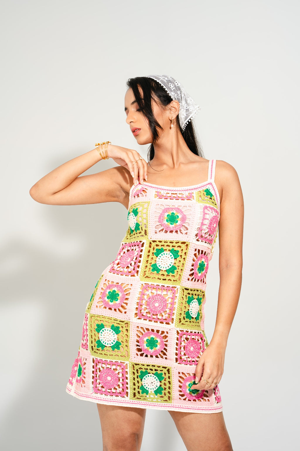 Back view of Suzy Bloom Crochet Mini Dress featuring intricate floral crochet squares – lightweight resort wear from Boarding Pass Store