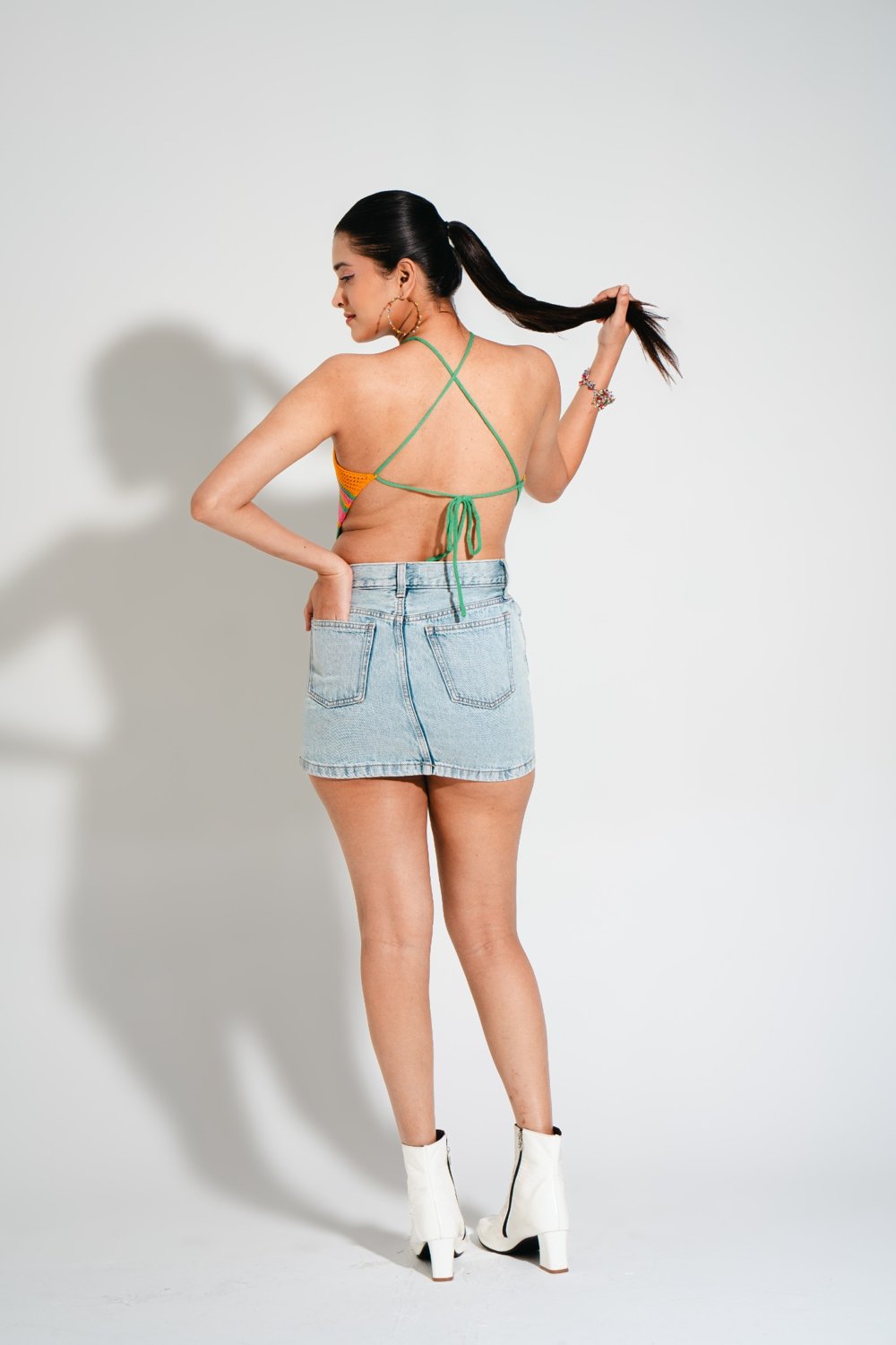 Back view of Candy Crochet Top with criss-cross tie-up straps, vibrant multicolor crochet pattern.