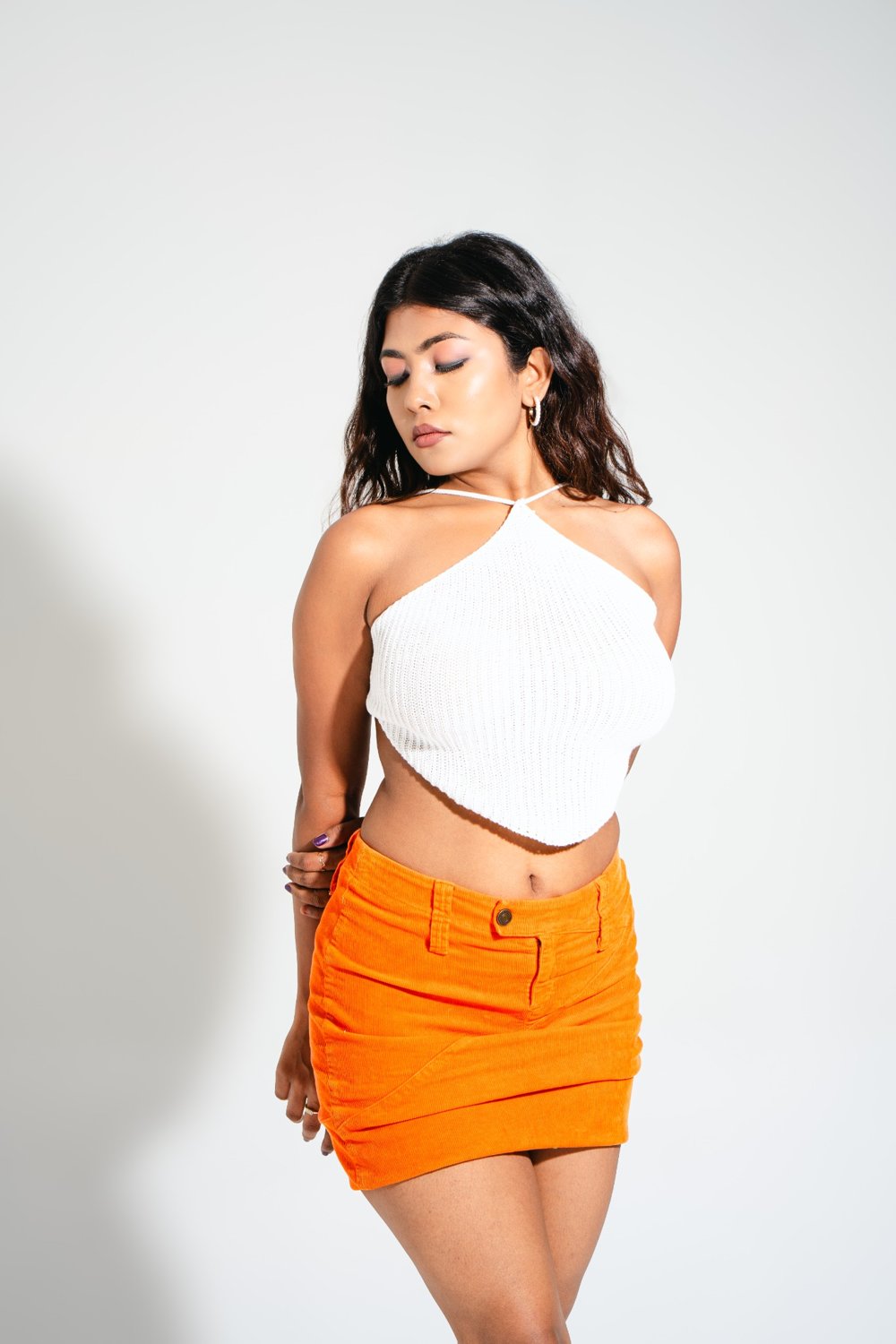 Front angle of Gia Cloud White crochet halter top, soft knit texture and pointed hem detail