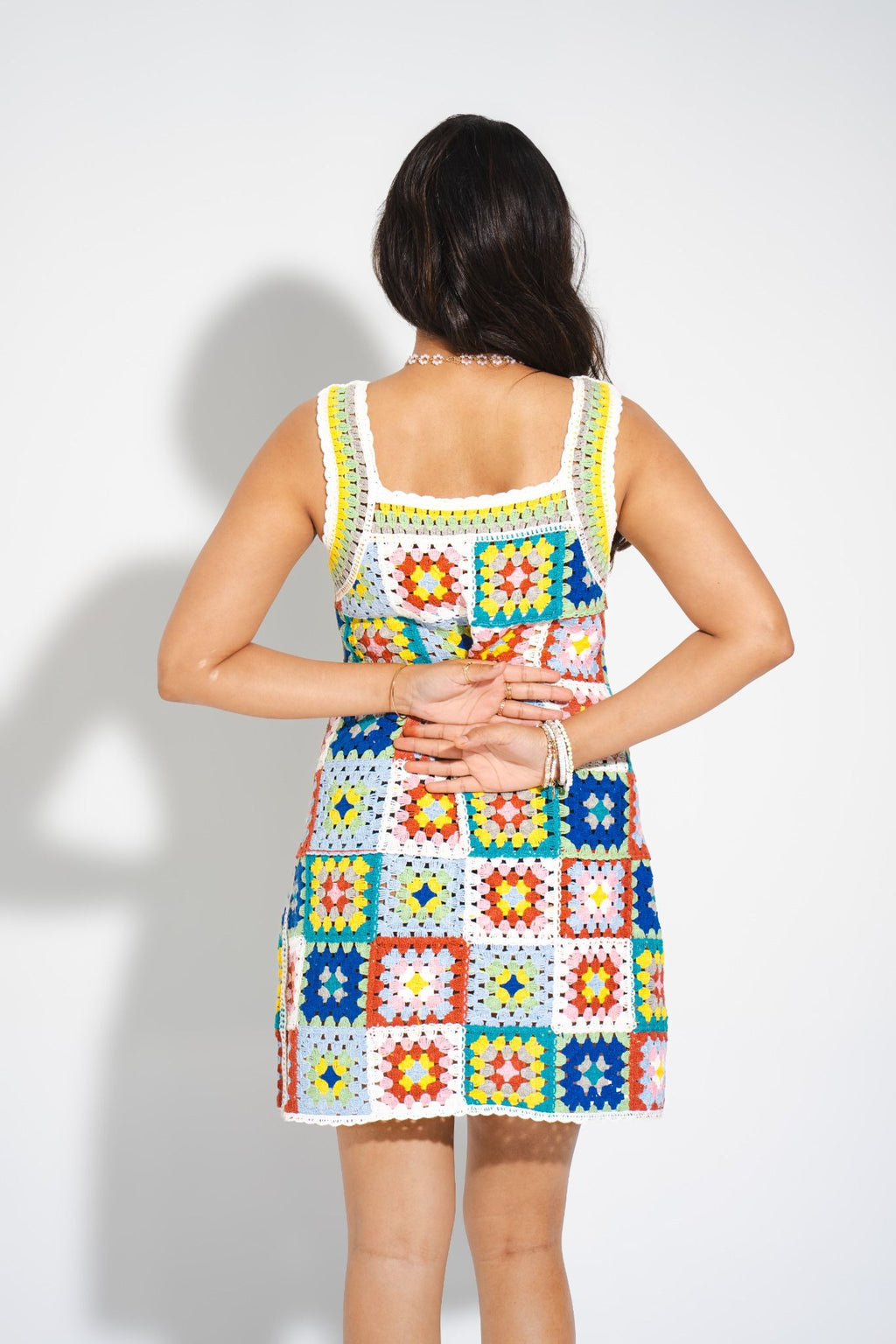 Back view of HAE Mosaic Crochet Mini Dress — vibrant resortwear with handcrafted crochet squares