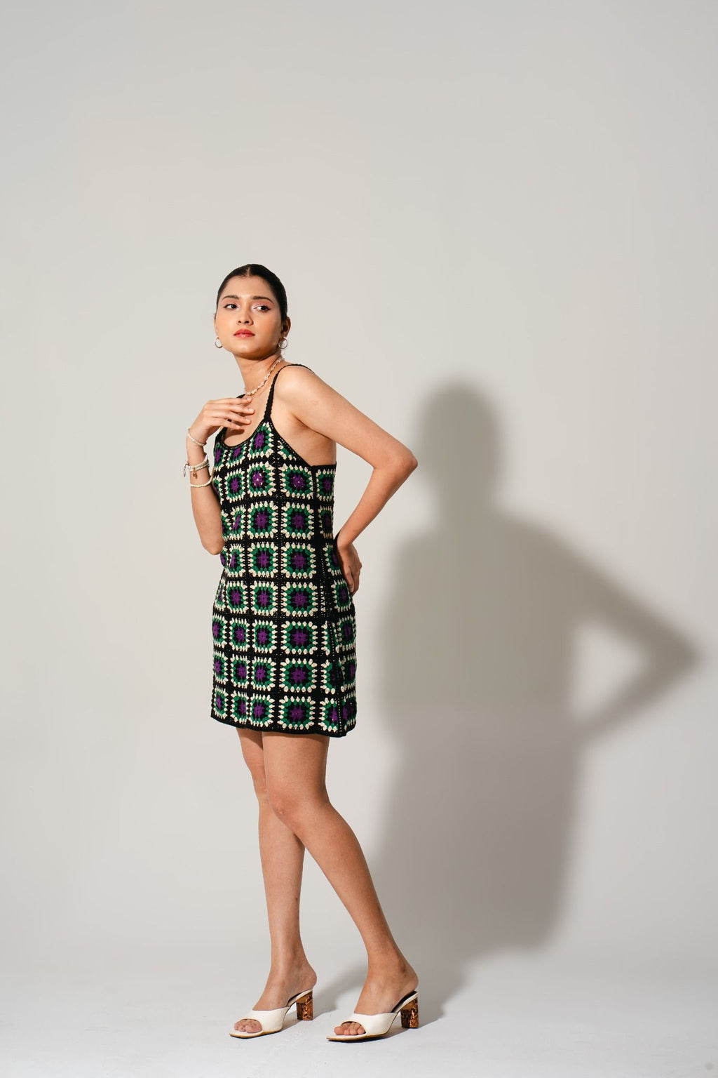 Side profile of Hana Cinder Crochet Mini Dress — boho mosaic crochet pattern perfect for vacations and brunch outfits.