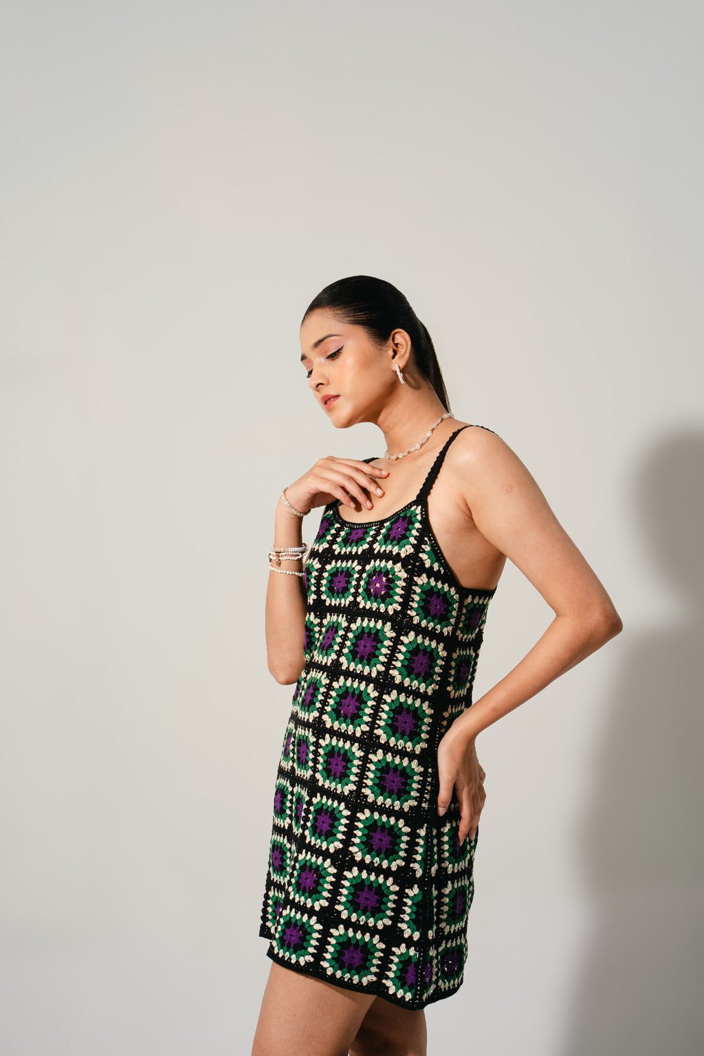 Full-length look of handcrafted Hana Cinder Crochet Mini Dress — lightweight summer resortwear in black and green tones