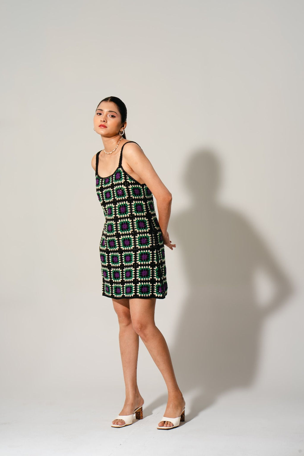 Hana Cinder Crochet Mini Dress in black with purple and green mosaic pattern — handcrafted boho mini dress by Boarding Pass Store.
