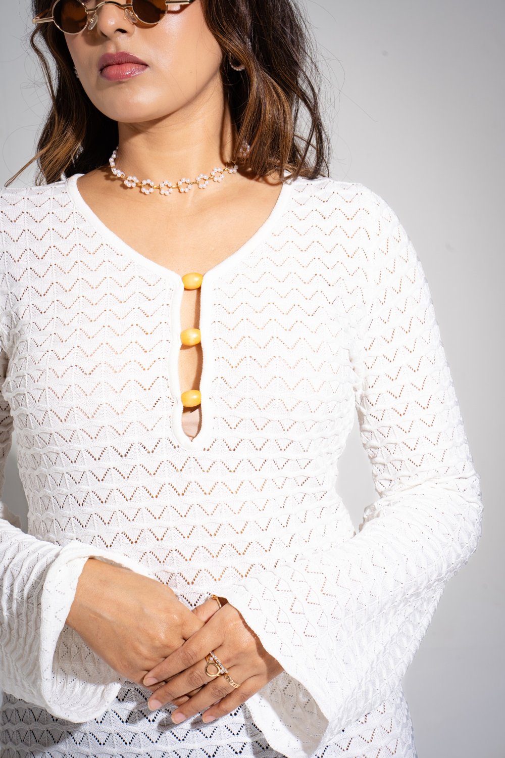 Chic white mini dress styled with woven beach bag — resortwear look by Boarding Pass